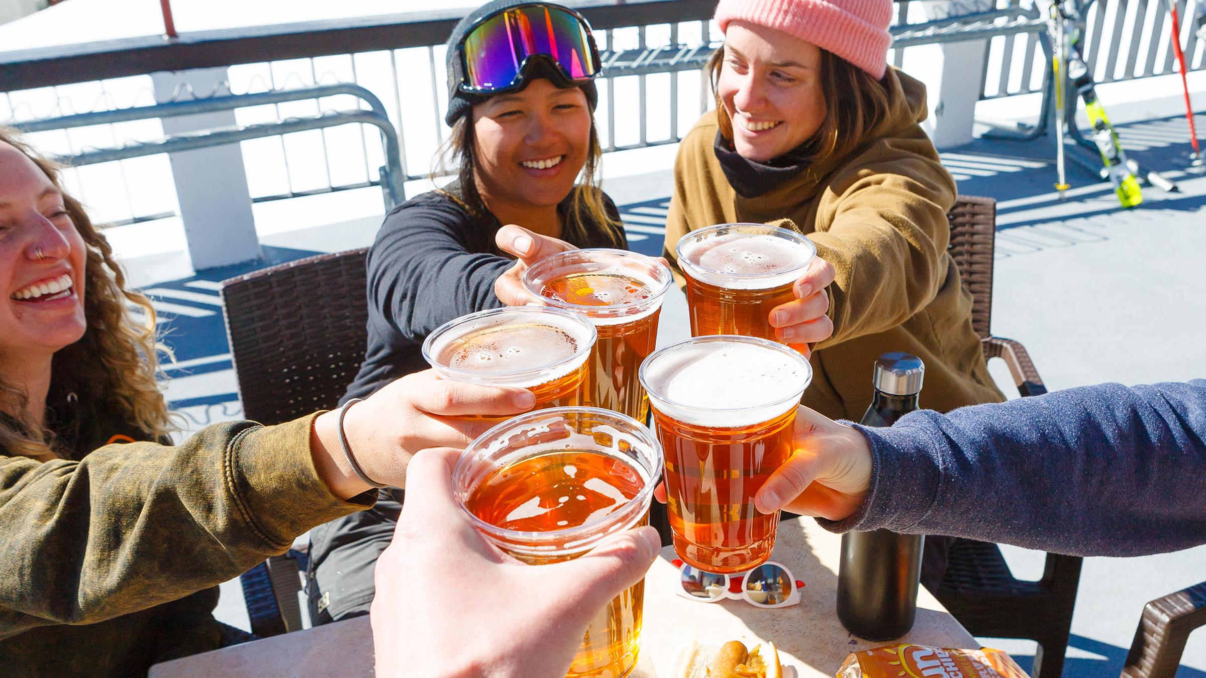 Women enjoy aprés beers from The Arc on the Gold Coast deck.