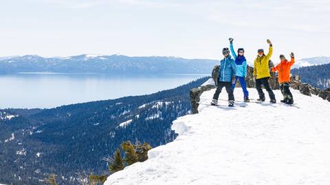 Aspirational lifestyles of a group of snowboarders looking out to Lake Tahoe from Alpine Meadows
