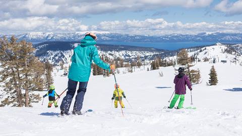 Family skiing at Squaw Valley with lake tahoe in the background