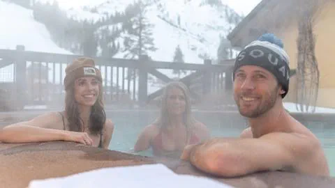 A group enjoying the hot tub on a cold morning with KT 22 in the background in the village at squaw valley