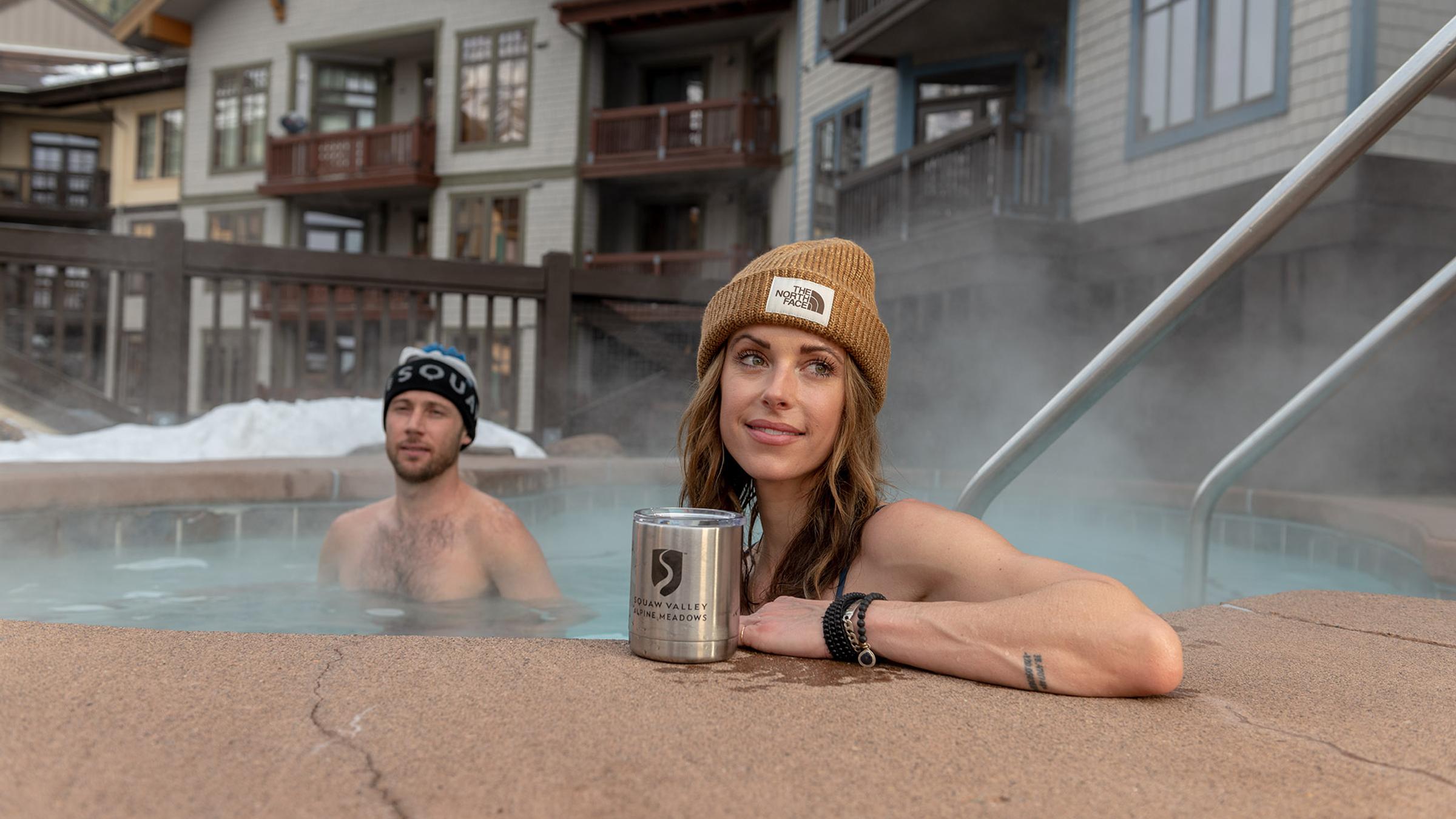 A man and woman soak in one of The Village at Squaw Valley's hot tubs