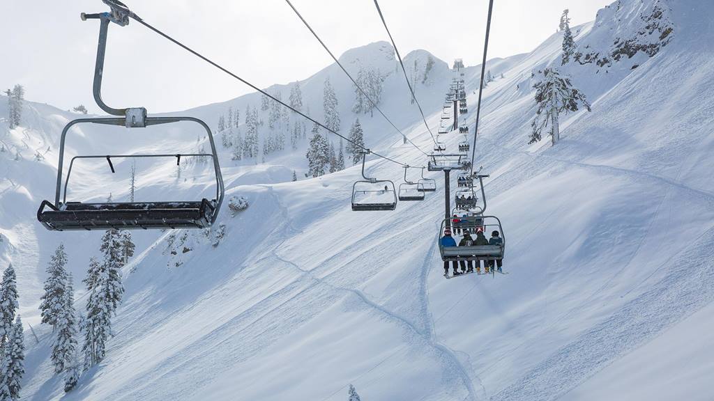 Riding deep powder on a storm day at Squaw Valley off KT-22
