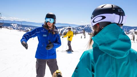 a teaching moment between an instructor and student during a Beginner Ski School photo shoot at Squaw Valley