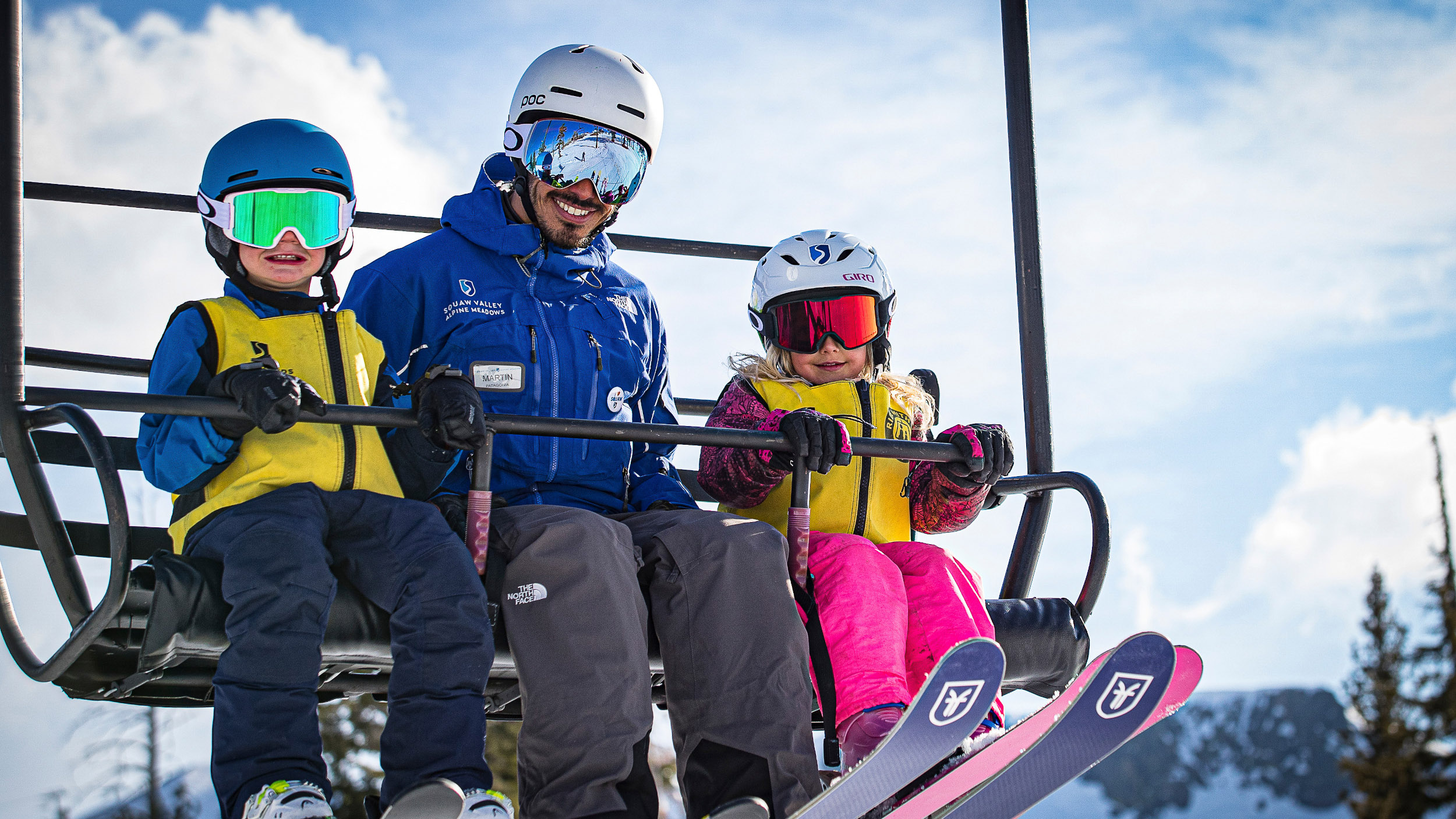 Kids ski school on chairlift with instructor