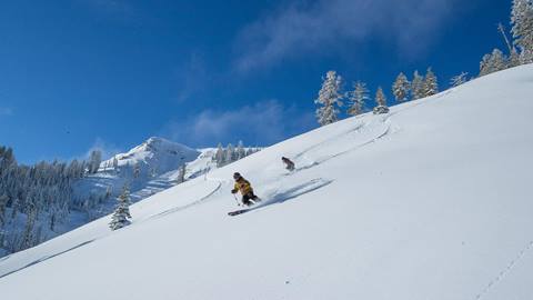 A couple powder skiing at Alpine Meadows