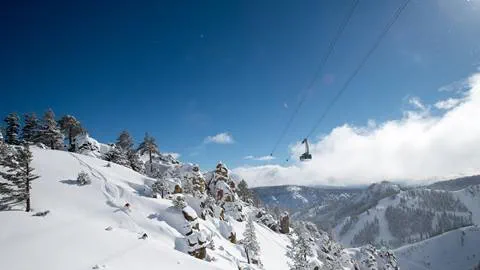 Skiers on Broken Arrow at Squaw Valley with Aerial Tram in the background